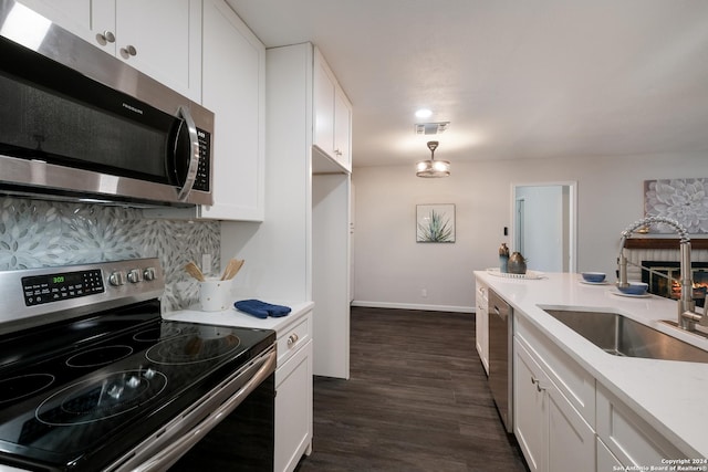 kitchen with sink, white cabinets, and stainless steel appliances