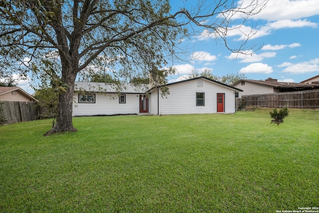 rear view of house with a yard