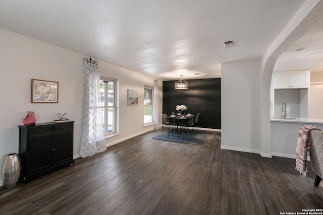 entrance foyer with dark hardwood / wood-style flooring, sink, and a chandelier