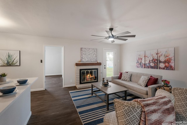 living room with a fireplace, ceiling fan, and dark hardwood / wood-style flooring