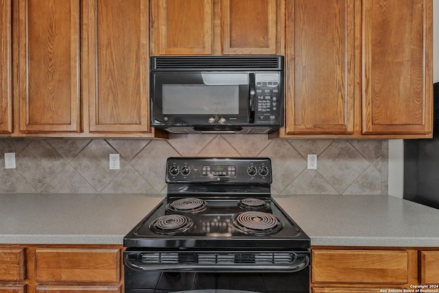 kitchen with tasteful backsplash and black appliances