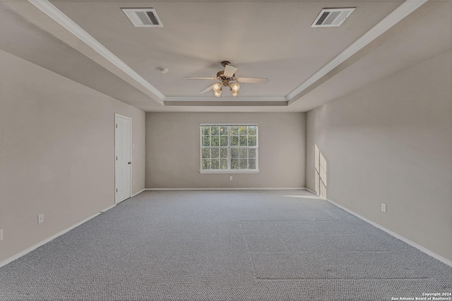 unfurnished room with light carpet, a raised ceiling, ceiling fan, and ornamental molding