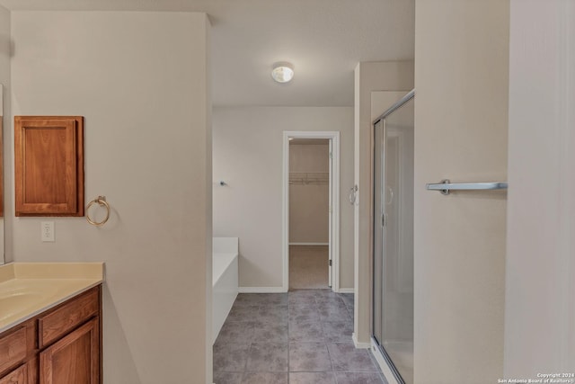 bathroom featuring tile patterned floors, vanity, and independent shower and bath