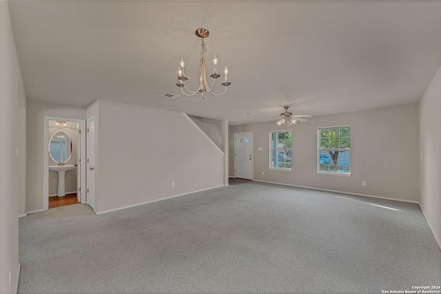 unfurnished living room with ceiling fan with notable chandelier, light colored carpet, and sink