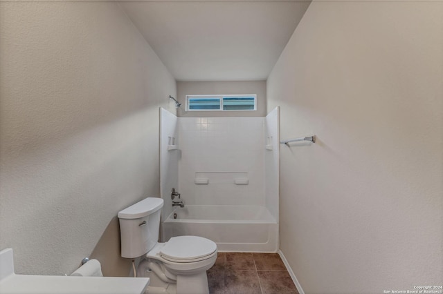 bathroom with tiled shower / bath combo and toilet