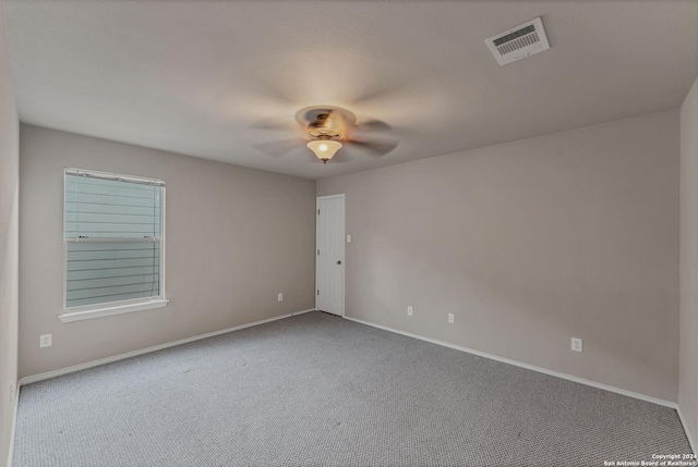 spare room featuring carpet flooring and ceiling fan