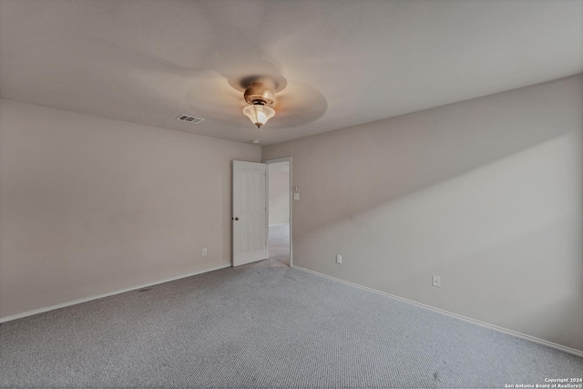 spare room featuring carpet flooring and ceiling fan