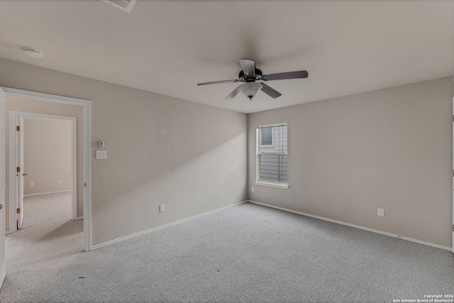 carpeted empty room featuring ceiling fan