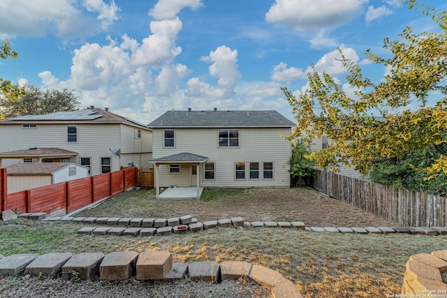 rear view of property with a yard and a patio