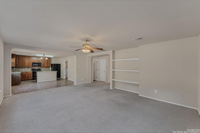 unfurnished living room with ceiling fan and light carpet