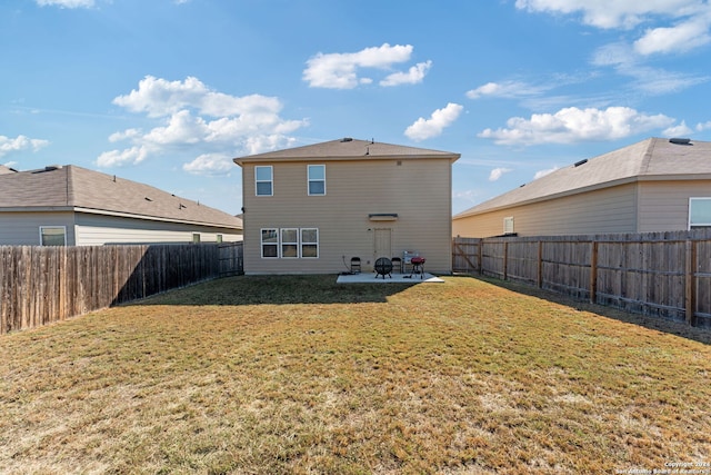 rear view of house with a lawn and a patio area