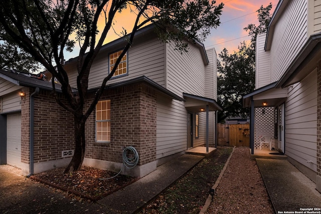 property exterior at dusk with a garage