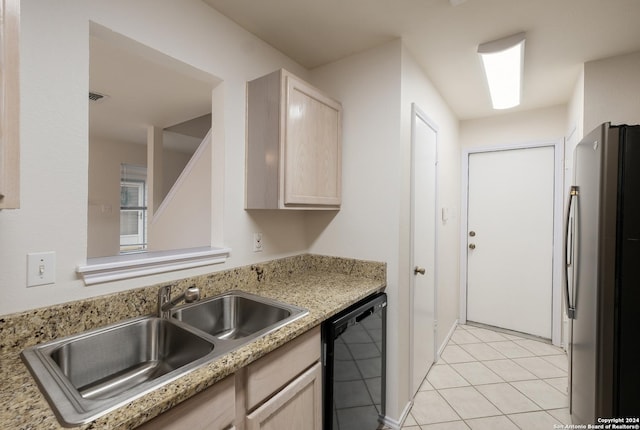 kitchen featuring dishwasher, sink, stainless steel fridge, light tile patterned floors, and light brown cabinetry