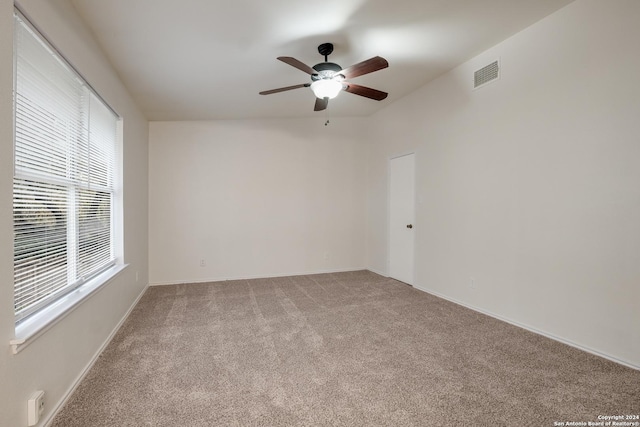 unfurnished room with ceiling fan and light colored carpet