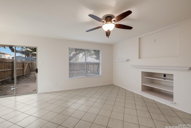 unfurnished living room featuring ceiling fan, light tile patterned flooring, and a wealth of natural light