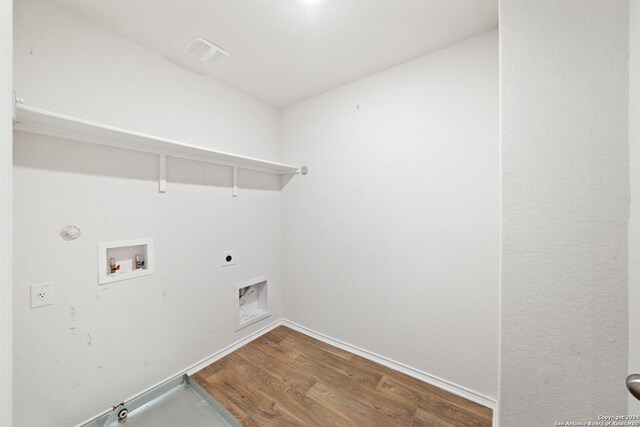 laundry room with wood-type flooring, electric dryer hookup, hookup for a gas dryer, and washer hookup