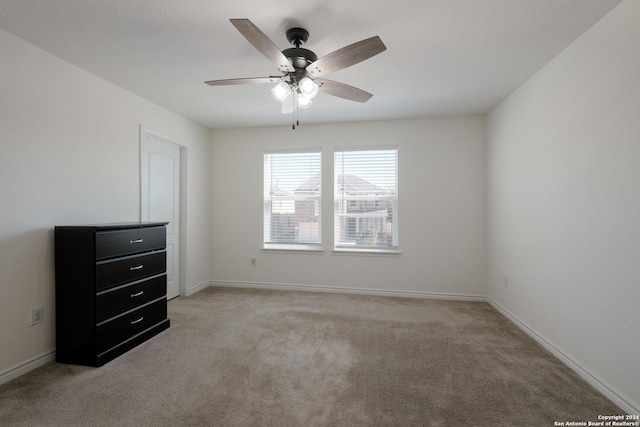 interior space with light colored carpet and ceiling fan