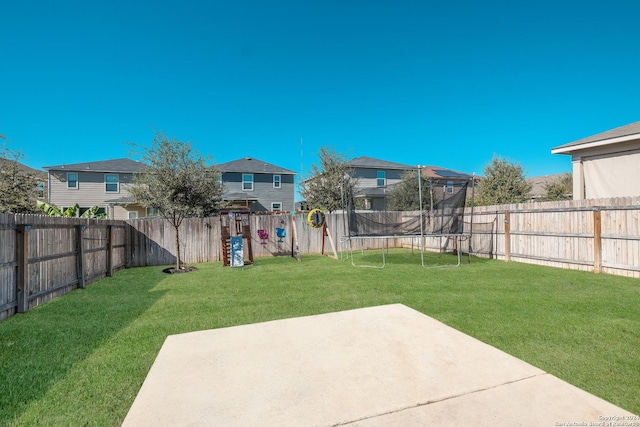 view of yard with a patio and a trampoline