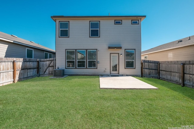 back of house with central AC, a yard, and a patio