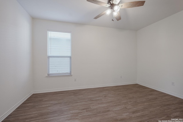 spare room with ceiling fan and dark hardwood / wood-style flooring