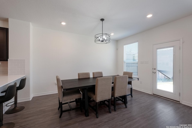 dining room with a wealth of natural light, a chandelier, and dark hardwood / wood-style floors