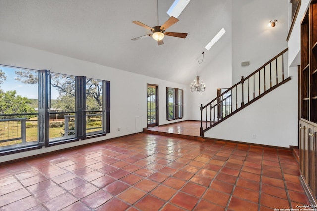 interior space featuring tile patterned floors, high vaulted ceiling, ceiling fan with notable chandelier, and a wealth of natural light