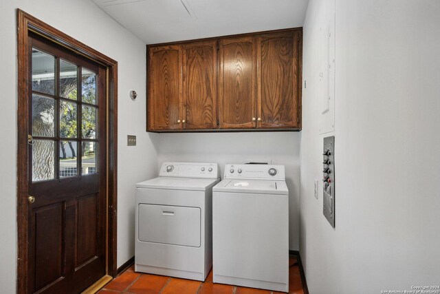 laundry area with light tile patterned floors, cabinets, and independent washer and dryer