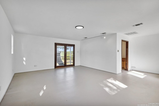 empty room with concrete flooring