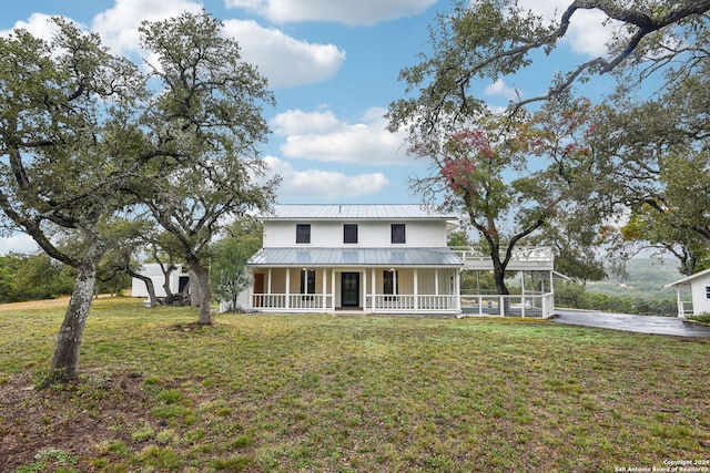 view of front of house with a porch and a front yard