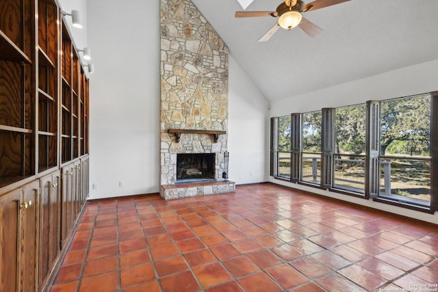 unfurnished living room with tile patterned flooring, high vaulted ceiling, ceiling fan, and a stone fireplace