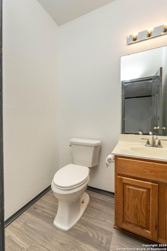 bathroom featuring hardwood / wood-style floors, vanity, and toilet