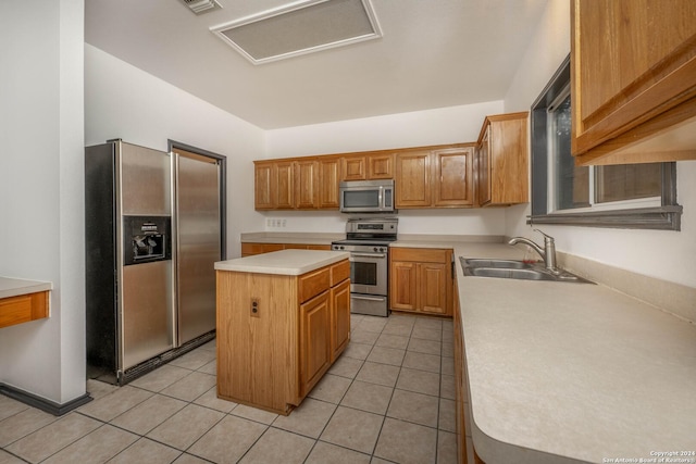 kitchen with a center island, sink, stainless steel appliances, and light tile patterned flooring