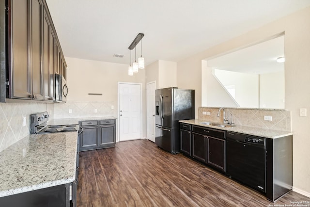 kitchen with sink, dark wood-type flooring, decorative light fixtures, and appliances with stainless steel finishes