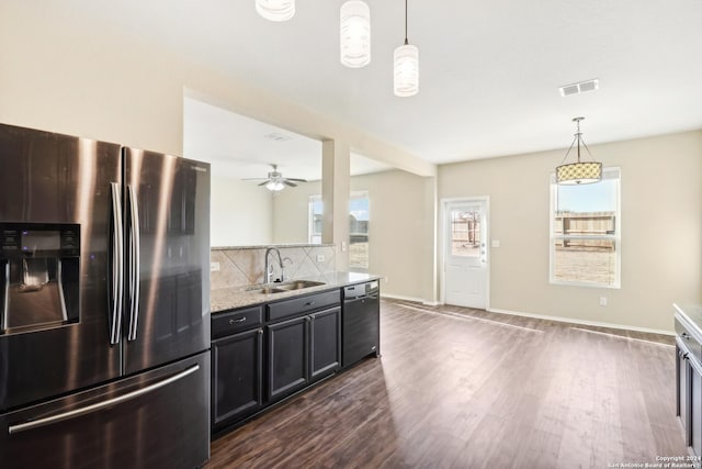 kitchen featuring dishwasher, stainless steel fridge, a wealth of natural light, and pendant lighting