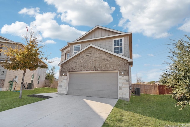 view of front of home with central AC unit, a garage, and a front lawn