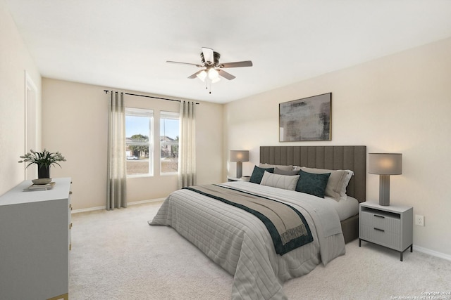 bedroom featuring ceiling fan and light carpet