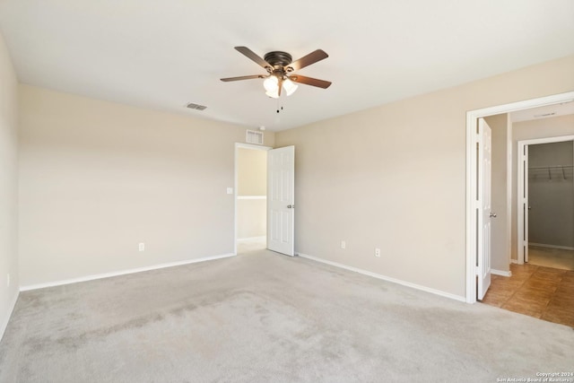 spare room featuring light carpet and ceiling fan