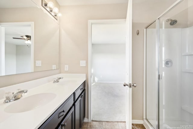 bathroom with ceiling fan, vanity, and a shower with shower door