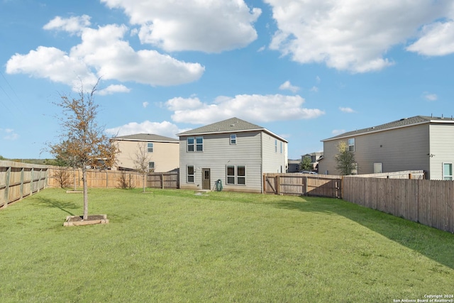 rear view of property with a lawn