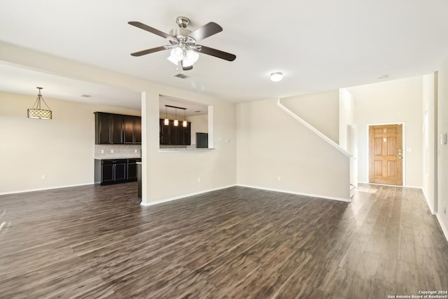 unfurnished living room with ceiling fan and dark wood-type flooring