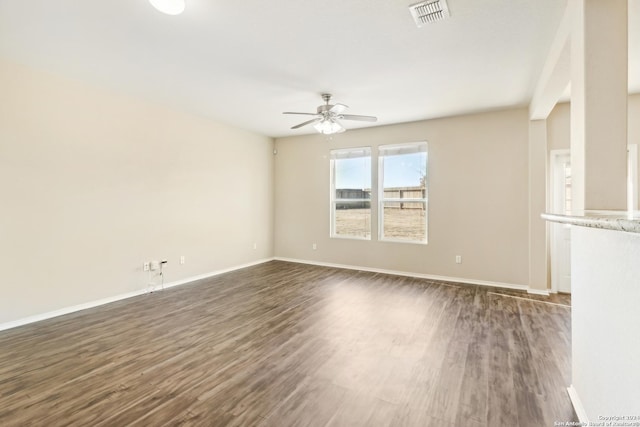 empty room featuring dark hardwood / wood-style flooring and ceiling fan