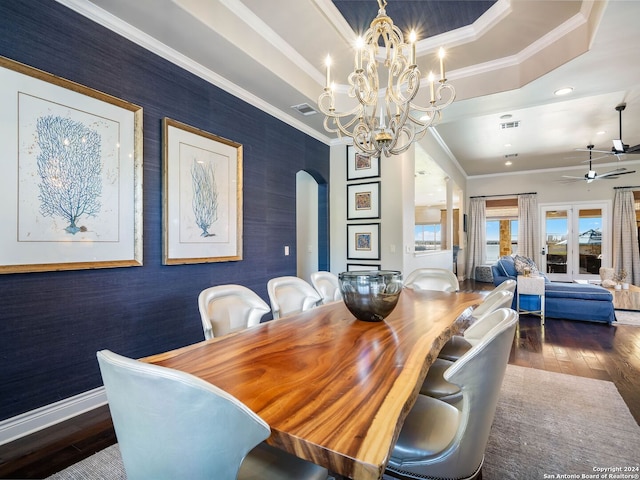 dining space with a tray ceiling, crown molding, ceiling fan with notable chandelier, and dark hardwood / wood-style floors