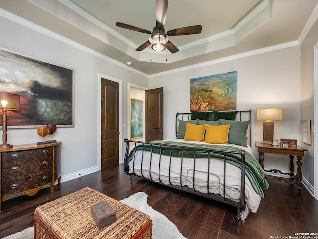 bedroom featuring a raised ceiling, ceiling fan, dark hardwood / wood-style flooring, and ornamental molding