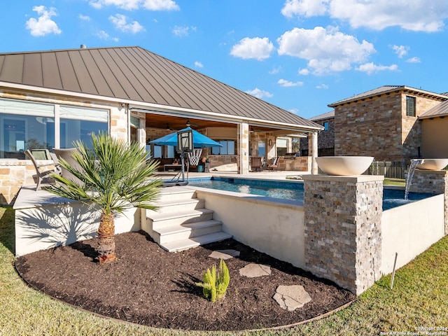 view of swimming pool with a patio area and exterior kitchen