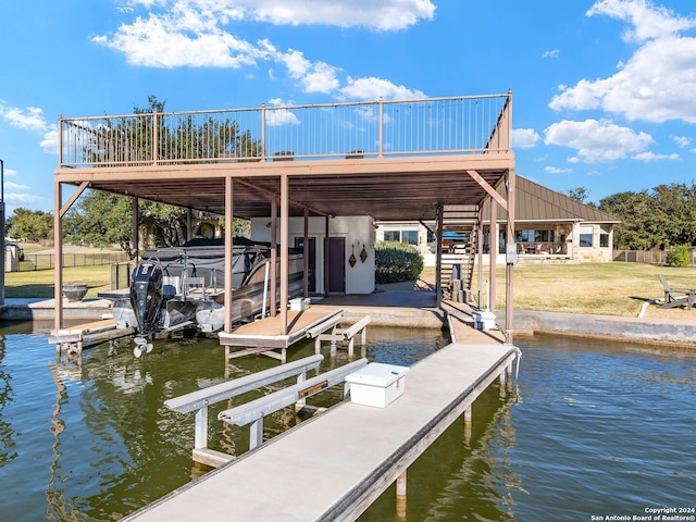 view of dock featuring a water view and a lawn