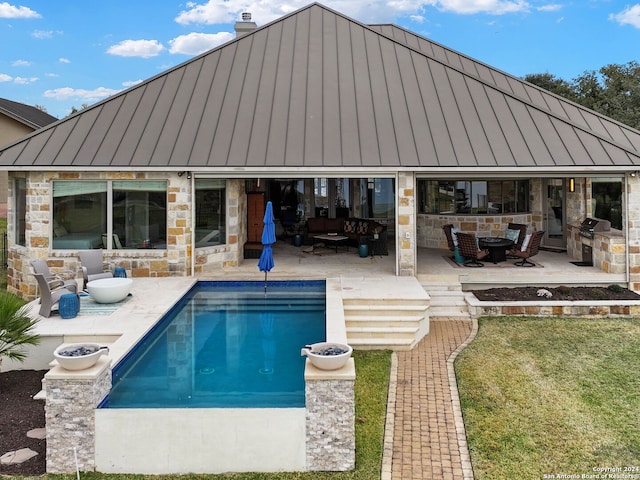 view of swimming pool featuring a patio, area for grilling, an outdoor fire pit, and a lawn