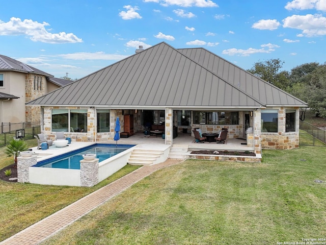 rear view of house with a patio and a lawn