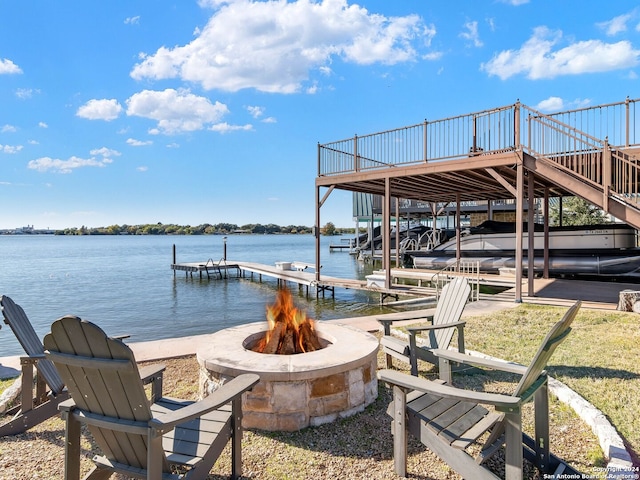 view of dock with a water view and an outdoor fire pit