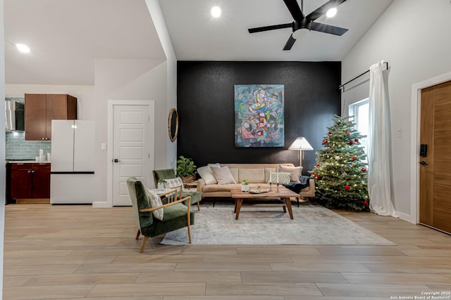 living room with ceiling fan and light wood-type flooring