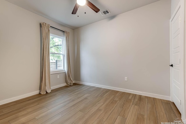 empty room featuring ceiling fan and light wood-type flooring